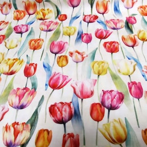 May include: Floral fabric with a watercolour design of tulips in red, pink, yellow, and orange. The tulips have green leaves and blue accents on a white background. The fabric is likely cotton or a similar material.