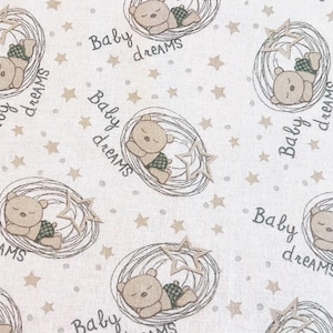 May include: A repeating pattern on a light beige fabric featuring sleeping teddy bears in nests, surrounded by stars and the words "Baby dreams". The bears wear green plaid diapers. The design is suitable for baby-themed products.