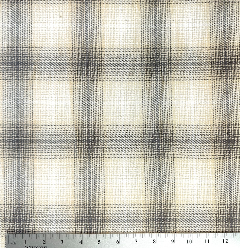 May include: Beige and gray plaid fabric with a subtle woven texture. The fabric is measured in inches.