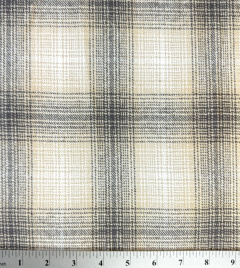 May include: A beige and gray plaid fabric with a subtle gradient effect. The fabric has a woven texture and a soft, comfortable feel.