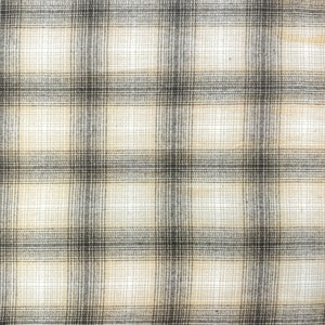 May include: A beige and black plaid fabric with a woven texture.