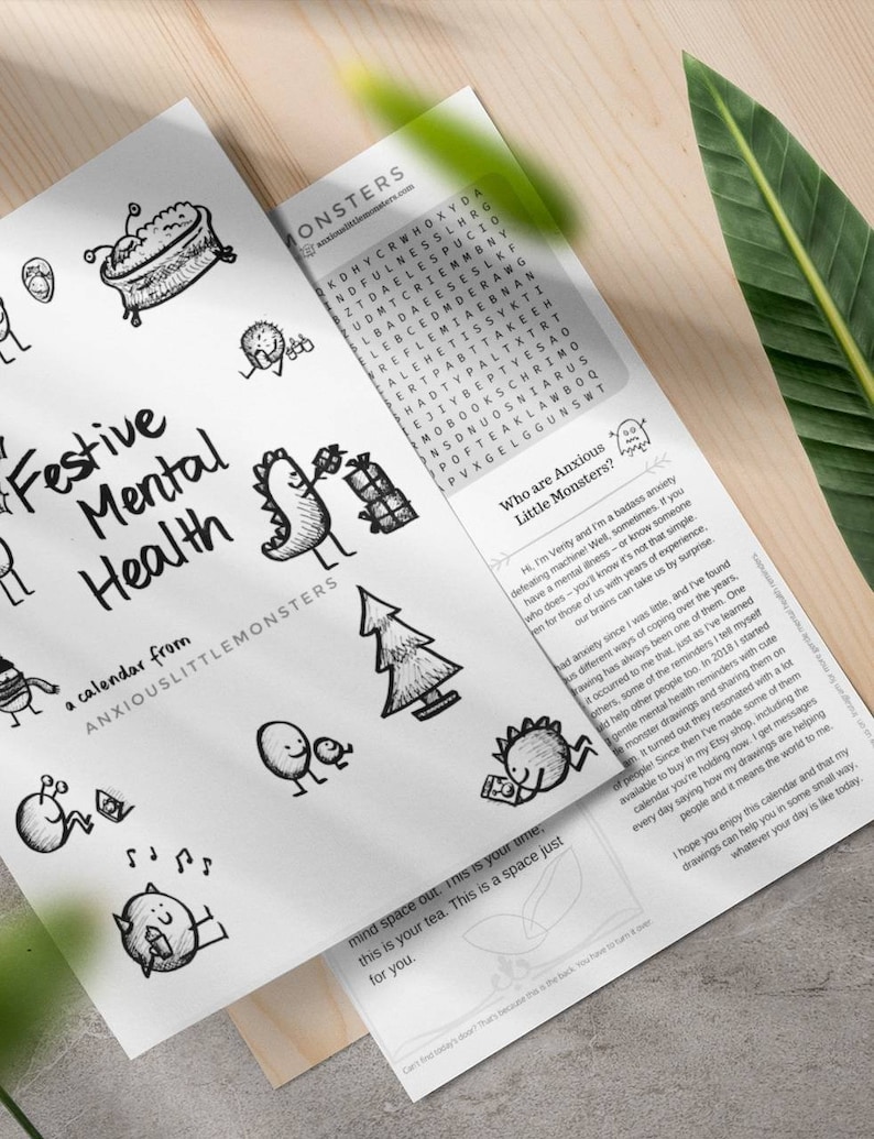May include: A calendar titled "Festive Mental Health" with whimsical black and white illustrations. The calendar includes a word search and text from Anxious Little Monsters. The design is on white paper.