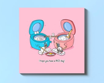 Op de afbeelding: Een roze kaart met een cartoonillustratie van twee rijstkokers, een blauwe en een roze, met de tekst "Ik hoop dat je een RICE-dag hebt!"