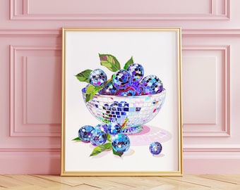 May include: A white bowl with a mirrored surface filled with blue and purple disco ball blueberries. The bowl is sitting on a white surface with a shadow underneath. The blueberries are surrounded by green leaves.