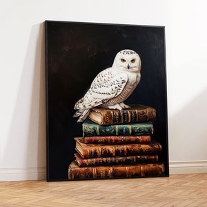 May include: A white snowy owl with yellow eyes perched on a stack of antique books against a dark background.