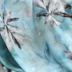 May include: Abstract blue and gray floral print fabric with a soft, flowing texture.