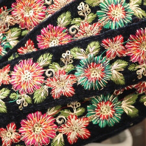 May include: Black velvet ribbon trim with gold, red, green, and pink embroidered floral designs.