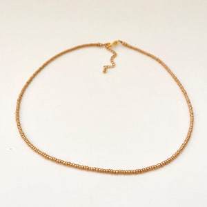 Golden Beaded Choker for Women Beach Wear Travel Jewelry Gold Seed Bead Necklace Dainty Layering Jewelry for Women Vacation Necklace Minimalist Gold Choker Delicate Handmade Boho Necklace Matte Gold Necklace Beaded Necklace Gift Idea for 16th Birthday Gift Idea for Friend
