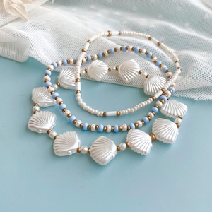 Coastal Boho Style Jewelry Collection Stackable Stretch Bracelet Set White Shell Bead Design Blue Summer Beach Accessory Seed Pearl Ocean Inspired Nautical Armband Seashell Gold Beaded Wrist Stack Three Piece Set Perfect Vacation Gift