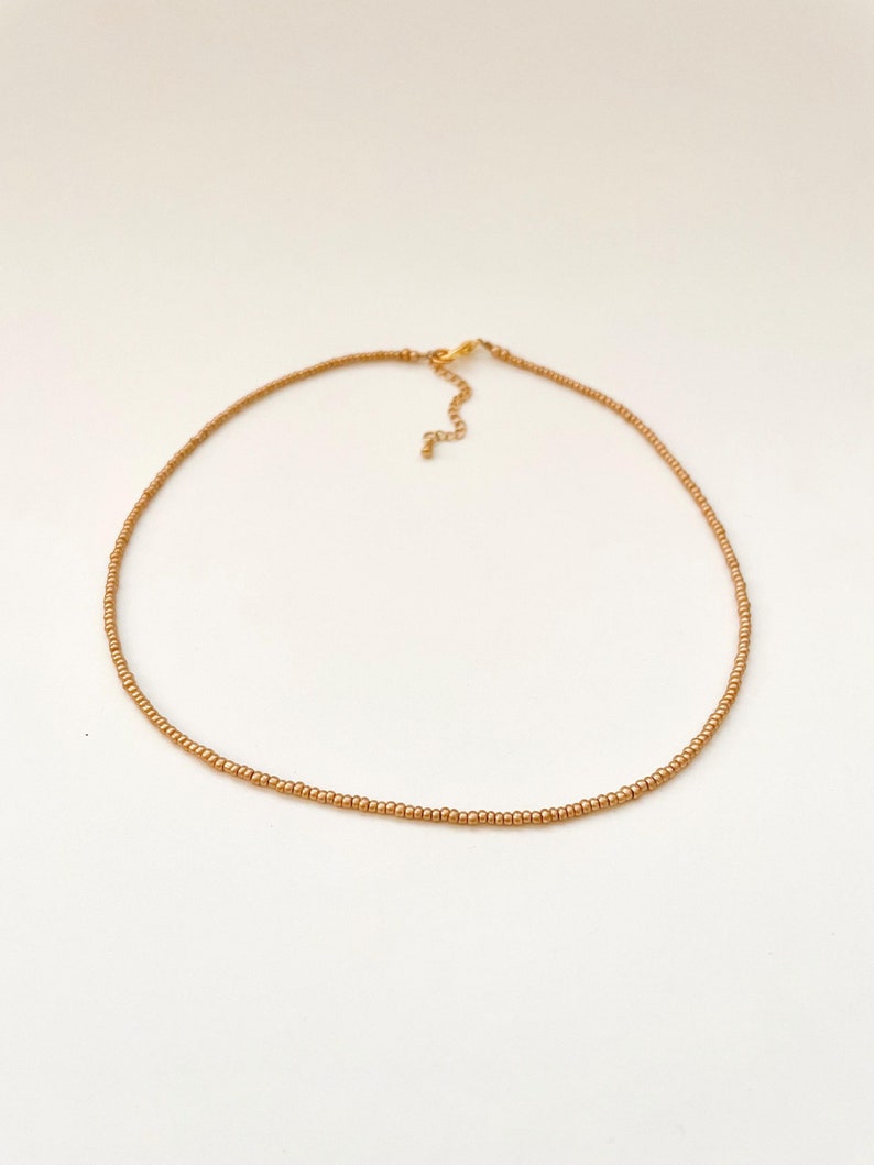 Golden Beaded Choker for Women Beach Wear Travel Jewelry Gold Seed Bead Necklace Dainty Layering Jewelry for Women Vacation Necklace Minimalist Gold Choker Delicate Handmade Boho Necklace Matte Gold Necklace Beaded Necklace Gift Idea for 16th Birthday Gift Idea for Friend