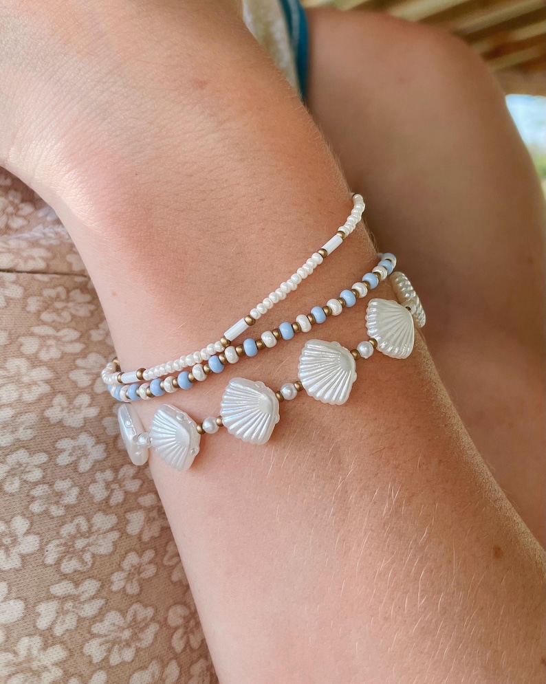 Stackable Stretch Bracelet Set Three Piece Collection White Shell Bead Jewelry Blue Summer Beach Style Coastal Boho Seed Pearl Design Ocean Inspired Nautical Armband Seashell Gold Copper Accent Beads Perfect Vacation Accessory Wrist Stack