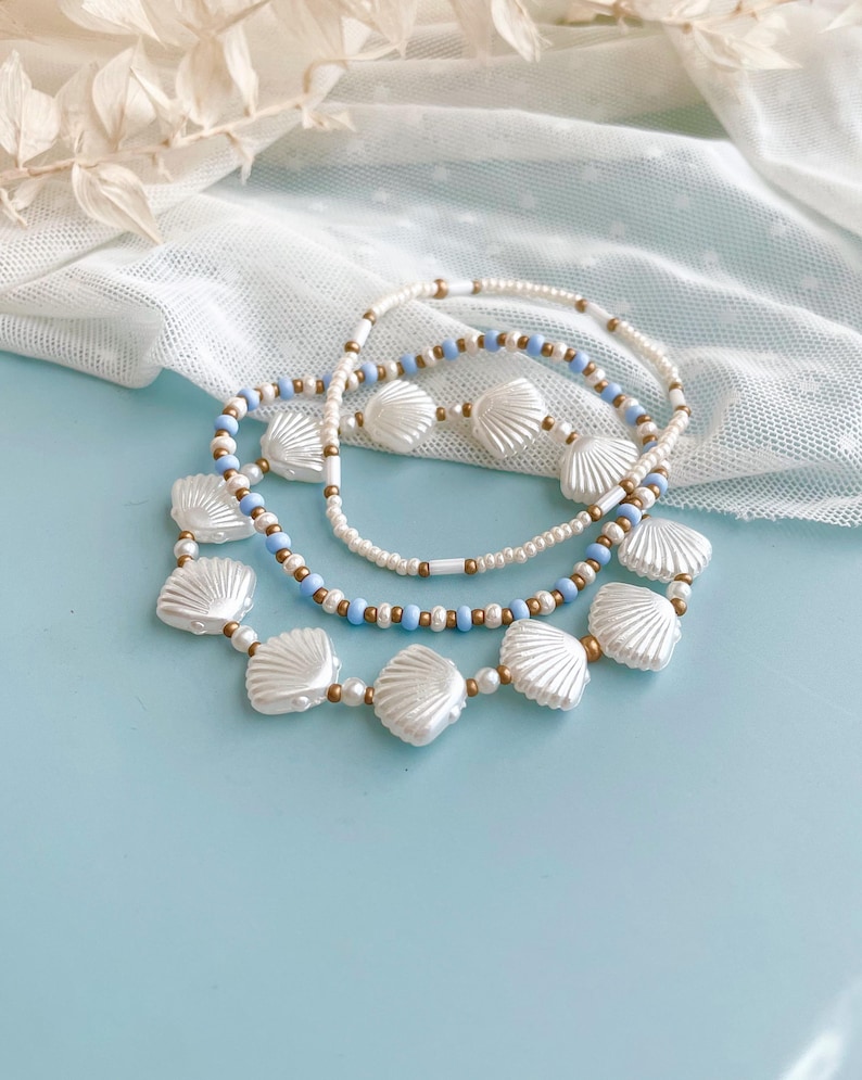Coastal Boho Style Jewelry Collection Stackable Stretch Bracelet Set White Shell Bead Design Blue Summer Beach Accessory Seed Pearl Ocean Inspired Nautical Armband Seashell Gold Beaded Wrist Stack Three Piece Set Perfect Vacation Gift