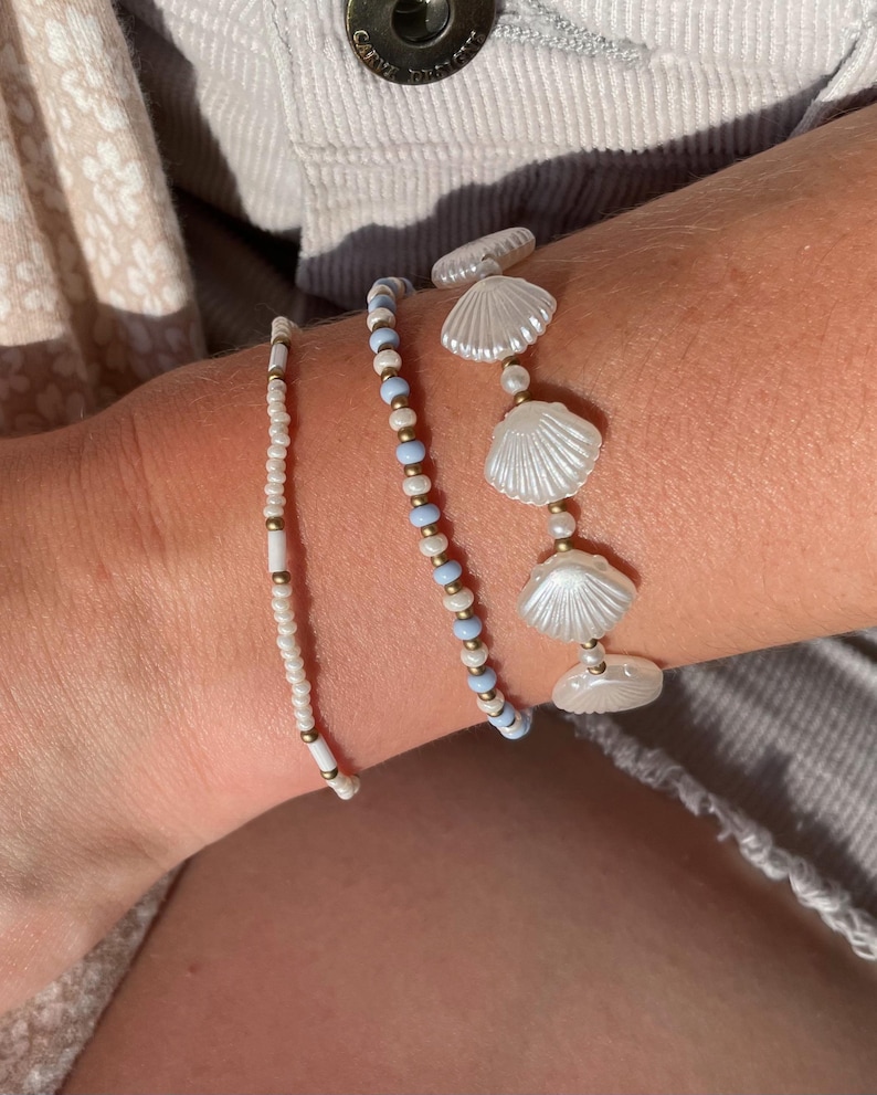 Seed Pearl Ocean Inspired Jewelry Stackable Stretch Bracelet Set White Shell Bead Collection Blue Summer Beach Style Coastal Boho Design Nautical Armband Seashell Gold Copper Beaded Wrist Stack Three Piece Set Perfect Vacation Accessory