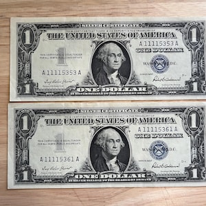 Two (2) - 1957 One Dollar Silver Certificates (Semi-Consecutive Pair) - About Uncirculated