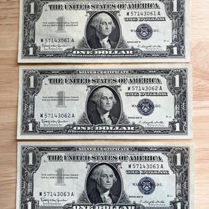 Three (3) - 1957 One Dollar Silver Certificates (Consecutive) - About Uncirculated