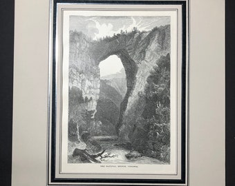 May include: Black and white framed print of the Natural Bridge in Virginia. The detailed engraving depicts the natural rock archway, surrounding cliffs, and a river below. The print is matted and framed with a black and silver border.