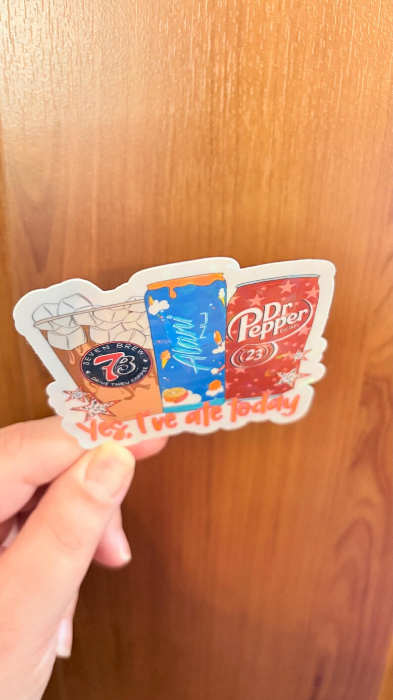 May include: A die-cut sticker featuring three beverage containers: a Seven Brew iced coffee with ice cubes, a blue Alani Nu energy drink, and a red Dr. Pepper can. The sticker includes the text "Yes, I've ate today" in orange script at the bottom.