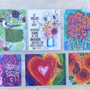 May include: Set of 10 colorful greeting cards with floral and nature-inspired designs. Each card features a different inspirational quote or message. The cards are perfect for sending a thoughtful message to a loved one.