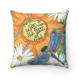 May include: Square throw pillow with a colorful floral design. The pillow features a large orange flower with the text "nothing can separate us from the love of God" and a dragonfly. White daisies are scattered around the design.