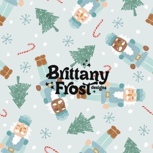 May include: A seamless pattern featuring a blue background with a repeating design of nutcracker figures, candy canes, snowflakes, and stylized Christmas trees. The text "Brittany Frost designs" is centered in the pattern.