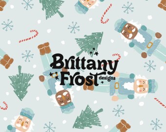 May include: A seamless pattern featuring a blue background with a repeating design of nutcracker figures, candy canes, snowflakes, and stylized Christmas trees. The text "Brittany Frost designs" is centered in the pattern.