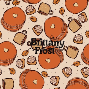 Puede incluir: Patrón repetitivo con panqueques naranjas con recortes en forma de corazón, rollos de canela, tazas de café y hojas de otoño. El diseño incluye el texto "Brittany Frost designs" en una fuente estilizada, sobre un fondo beige con pequeños puntos negros.