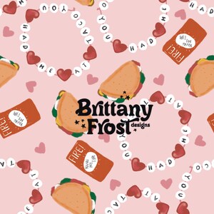 May include: A pink background with a repeating pattern of tacos, hearts, and a string of hearts with the words "YOU'RE MY TYPE" on each heart. The text "Brittany Frost designs" is in the center of the image.