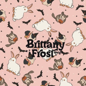 May include: A pink background with a repeating pattern of white rabbits, grey chinchillas, and bats. The chinchillas are holding pumpkins and the rabbits are wearing ghost costumes. The text "Brittany Frost designs" is in the centre of the image.