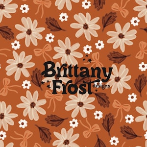 May include: A repeating pattern of flowers, bows, and leaves in shades of white, beige, and brown on a rust-colored background. The text "Brittany Frost designs" is in black script.