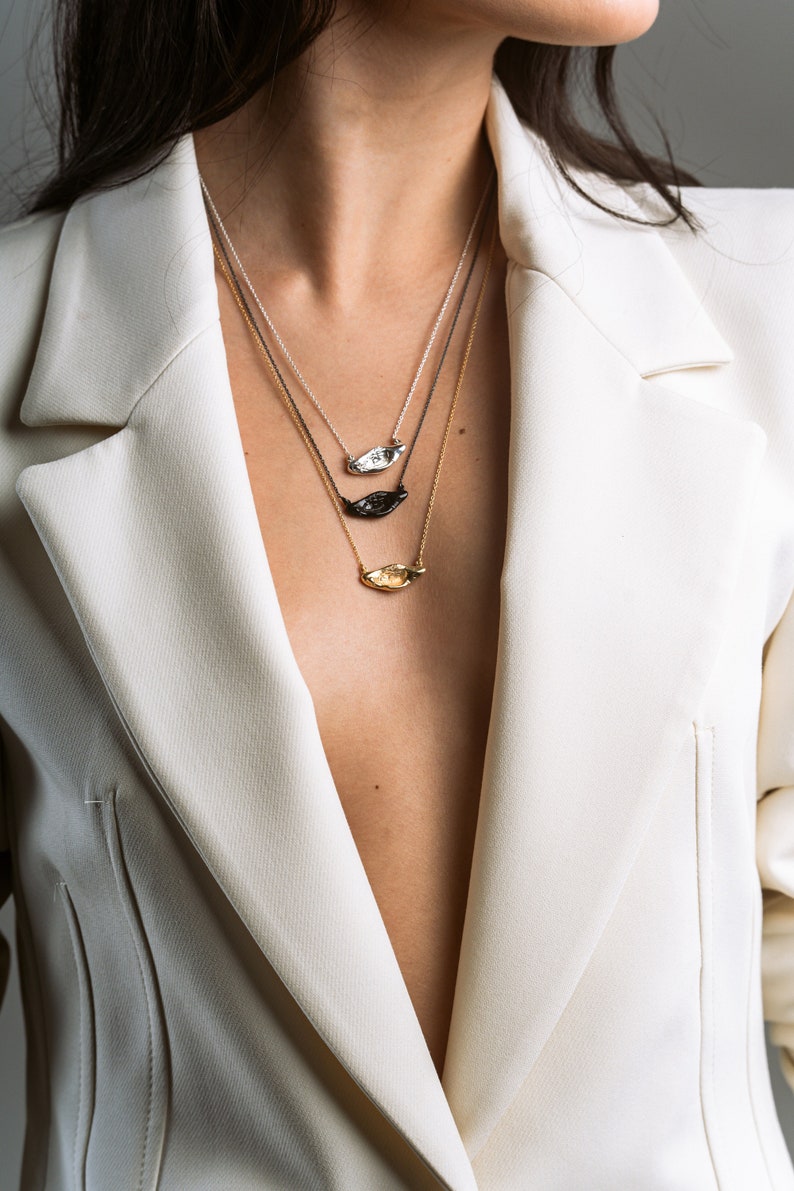 Picture the Aura necklace – a stunning organic jewelry piece in polished silver, gold-plated, and black-plated options. Handcrafted for uniqueness and contemporary charm. #AuraNecklace #HandcraftedJewelry