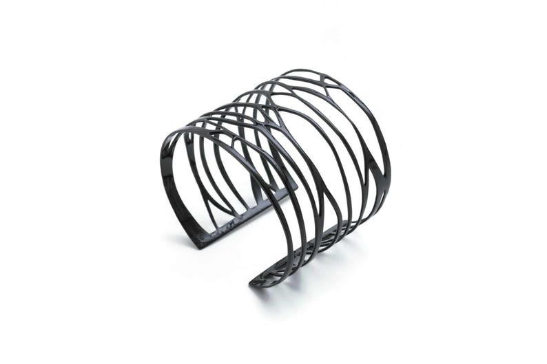 Wide Cuff Bracelet in black-plated silver with intricate branch patterns—an artistic piece for women seeking bold accessories.