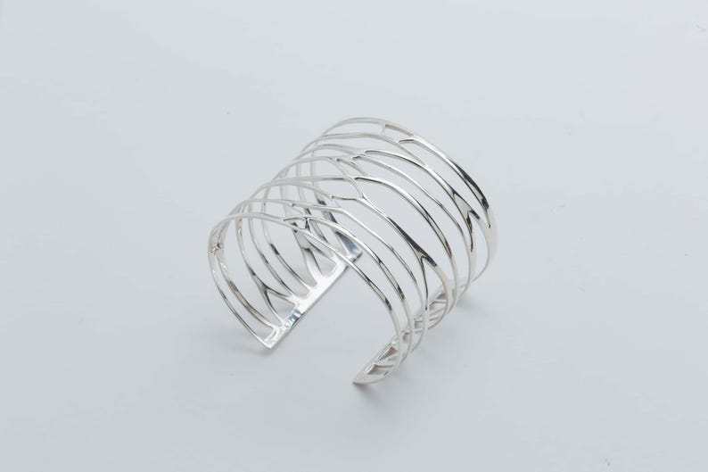 Handcrafted Silver Cuff Bracelet in pure silver, offering a perfect blend of elegance and bold design for modern women.