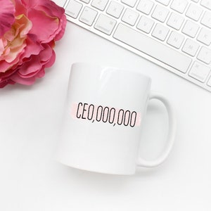 Girl Boss Mug with the text in black CEO,000,000 with a pink stripe across it