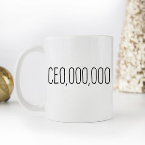 Op de afbeelding: Witte keramische koffiemok met een zwarte inscriptie die "CEO,000,000" luidt.