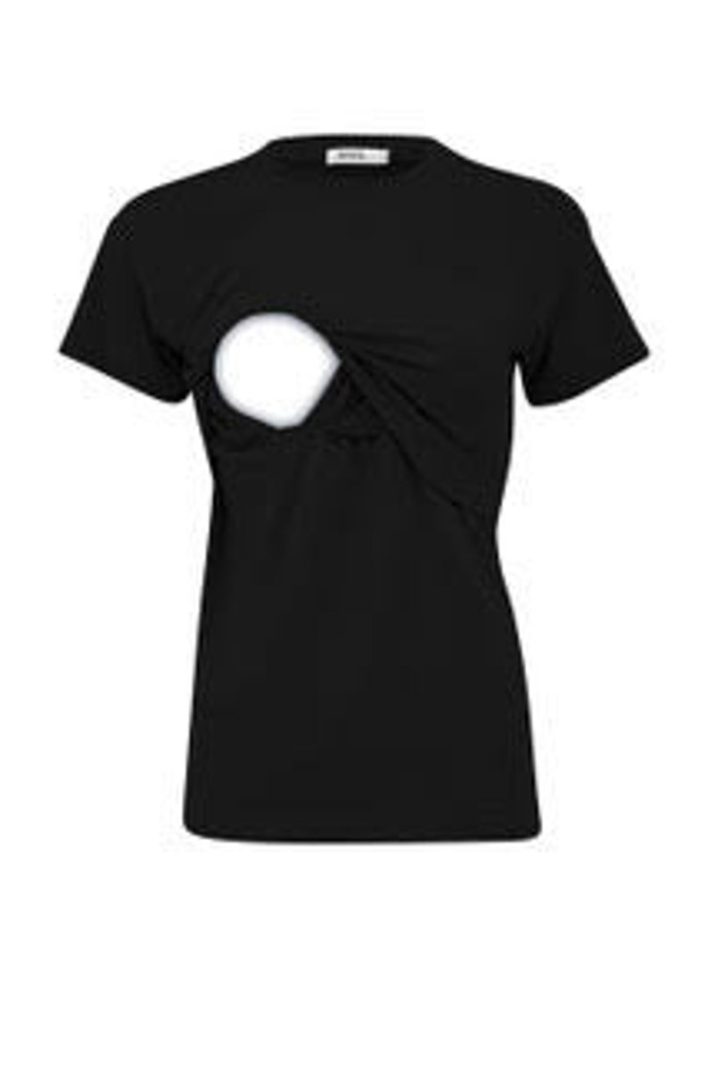 May include: A solid black short-sleeved t-shirt featuring a round neckline and a distinct circular cutout detail on the upper chest area. The garment has a plain hemline and a small white rectangular brand label attached to the inside of the collar.