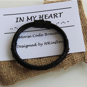 May include: A black leather bracelet with a message in Morse code that reads "IN MY HEART". The bracelet is packaged in a hessian bag with a card that says "Morse Code Bracelet Designed by NRinfin&iacute;".
