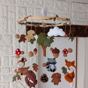 Felt baby mobile on the theme of forest animals, fox, raccoon, bear, deer, autumn, acorn, tree, mushroom