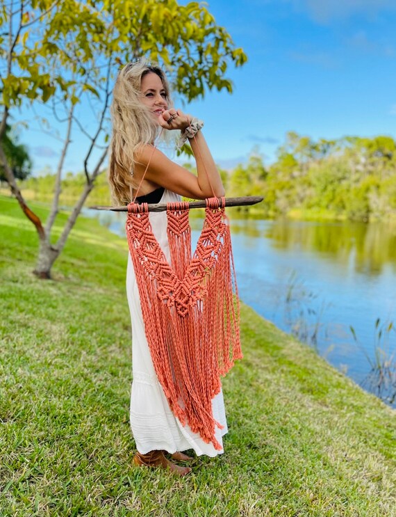 Goddess-form macrame on actual driftwood — the natural found-wood mounting piece makes this genuinely one-of-a-kind rather than another rope-on-dowel wall hang.