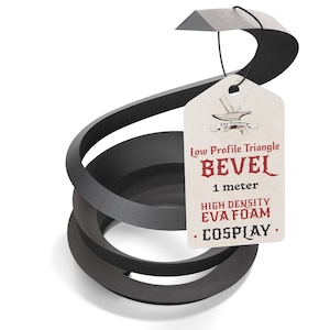 May include: A black, coiled, low-profile triangle bevel made of high-density EVA foam. A white tag is attached with a black string, featuring the text: The Foamory, Low Profile Triangle BEVEL, 1 meter, HIGH DENSITY EVA FOAM, COSPLAY.