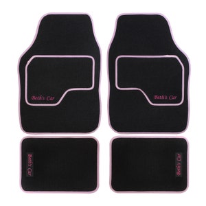 May include: Set of four black car floor mats with pink edging and the text "Beth's Car" embroidered in pink.