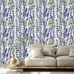 May include: A watercolor-style wallpaper featuring a repeating pattern of lavender sprigs with purple flowers and green leaves against a white background. The image shows a living room with a beige sofa and wooden coffee table.