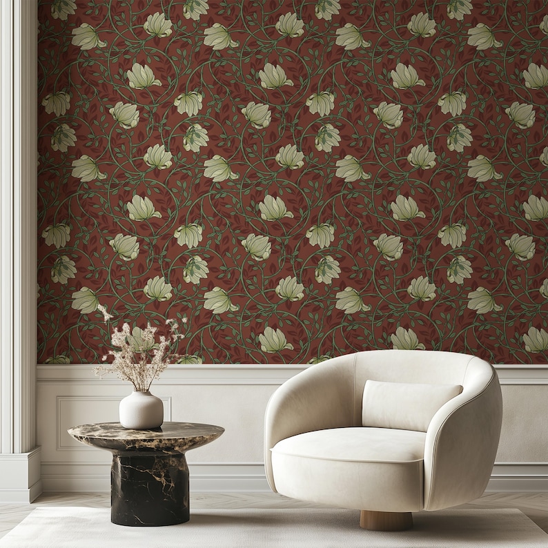 May include: A white armchair with a red floral wallpaper background. The wallpaper features a repeating pattern of white flowers and green vines.