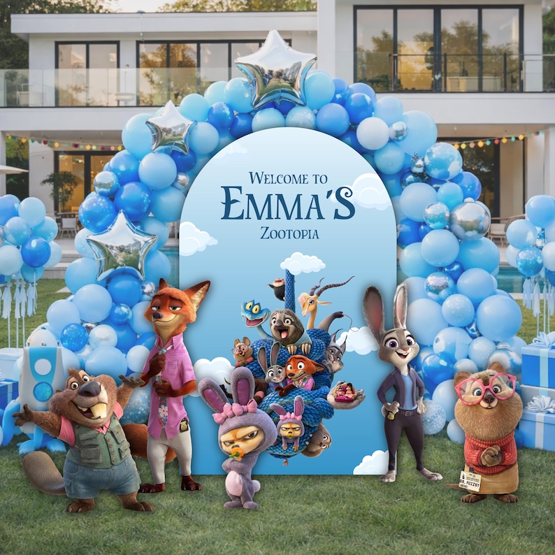 May include: A blue arched backdrop featuring the text Welcome to Emma's Zootopia, surrounded by a large balloon garland in shades of blue and white with silver star-shaped balloons. Several Zootopia character figures stand in front.