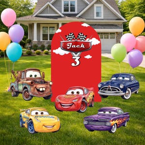 May include: A birthday party scene with cartoon car cutouts and colorful balloons. The red backdrop features the name "Jack" and the number "3". The cars include Mater, Lightning McQueen, and other characters from the Cars movie.