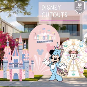 May include: Disney cutouts featuring a pink and blue castle, a Mickey Mouse character in a unicorn costume, and a Ferris wheel. The backdrop includes a pink arch with the text "Audreyland" and a Mickey Mouse silhouette.