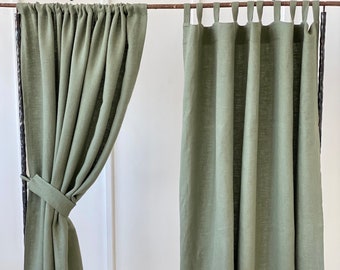 May include: Two green linen curtains hanging on a rod. The curtain on the left has a rod pocket and the curtain on the right has tab top headers.