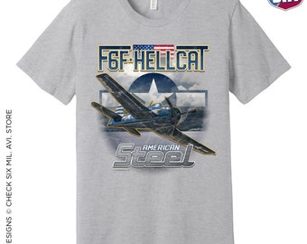 May include: A gray t-shirt with a vintage-style graphic of a blue F6F Hellcat fighter plane with the text "American Steel" underneath. The graphic also includes a red, white, and blue American flag and a star.