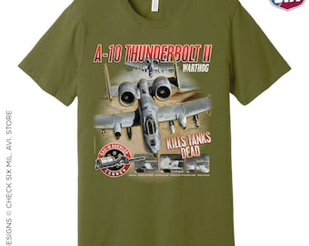 May include: A green t-shirt with a graphic of an A-10 Thunderbolt II Warthog airplane. The graphic includes the text "A-10 Thunderbolt II Warthog", "GAU-8 Avenger Cannon", "Kills Tanks Dead", and "30mm Depleted Uranium Armor-Piercing Rounds".