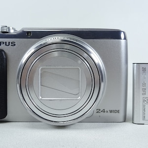 Olympus Stylus SH-50 Digital Compact Camera - Silver Color with Battery In Good Condition.