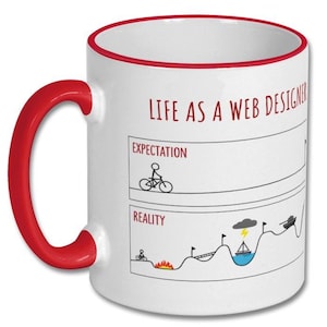 May include: White ceramic mug with a red handle and rim. The mug features the text "LIFE AS A WEB DESIGNER" and a graphic comparing expectations to reality, including a cyclist, fire, and a boat.